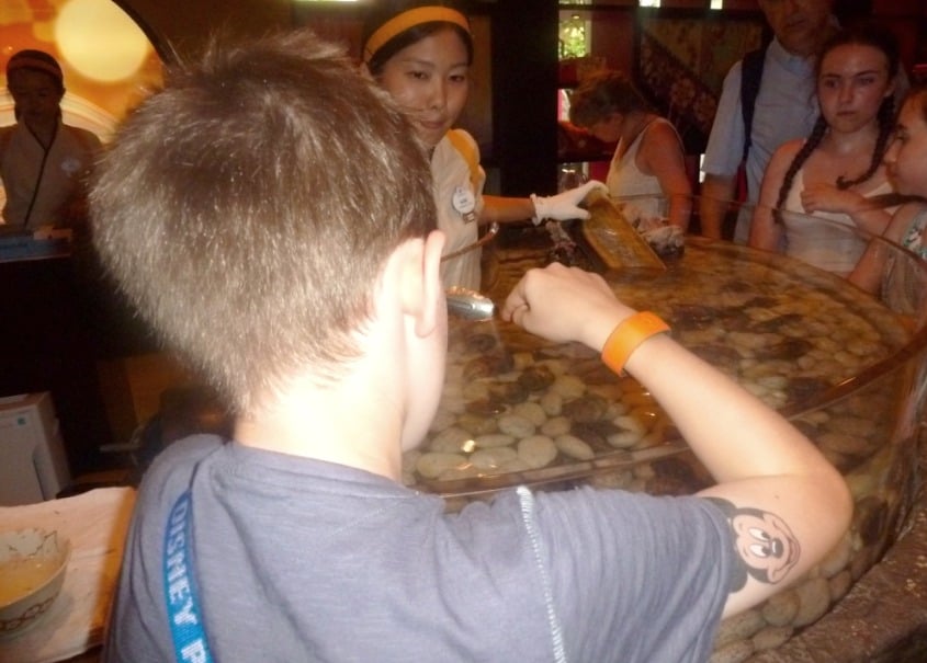 Things To Do At Epcot With Teens www.extraordinarychaos.com Buying a Oyster at Japan at Epcot Walt Disney World www.extraordinarychaos.com