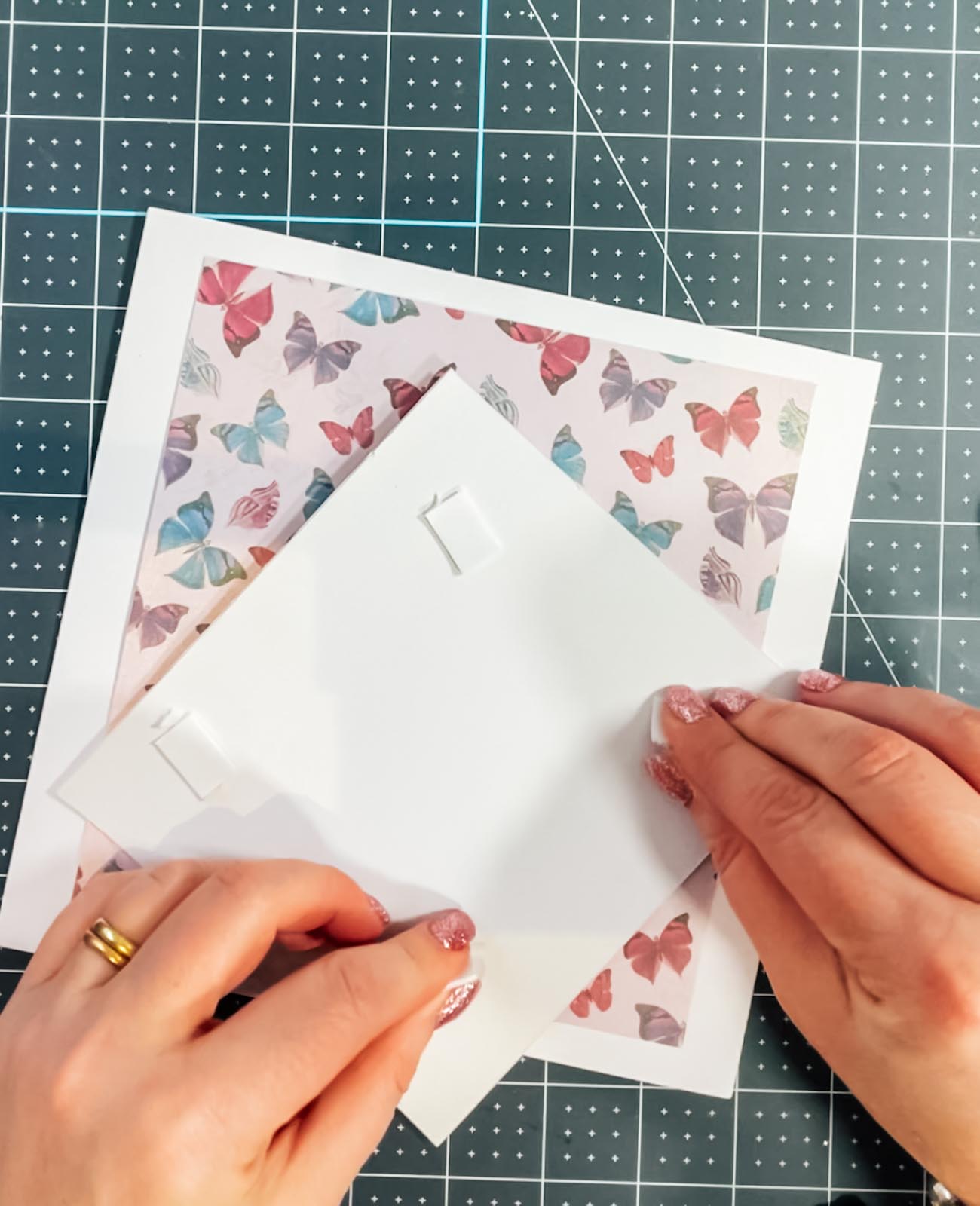 Attaching corrugated card with sticky pads.