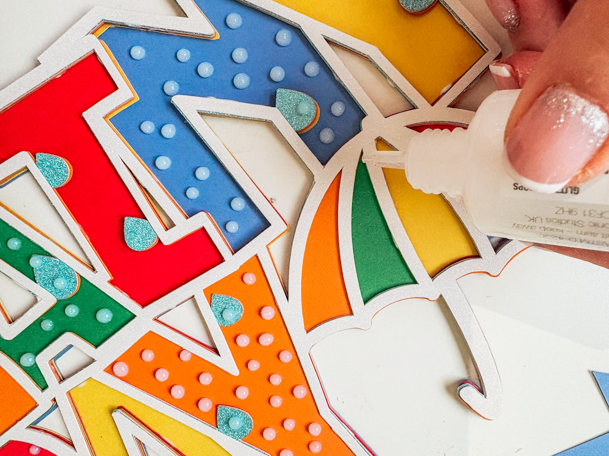 Create rain drops by decorating with Nuvo drops