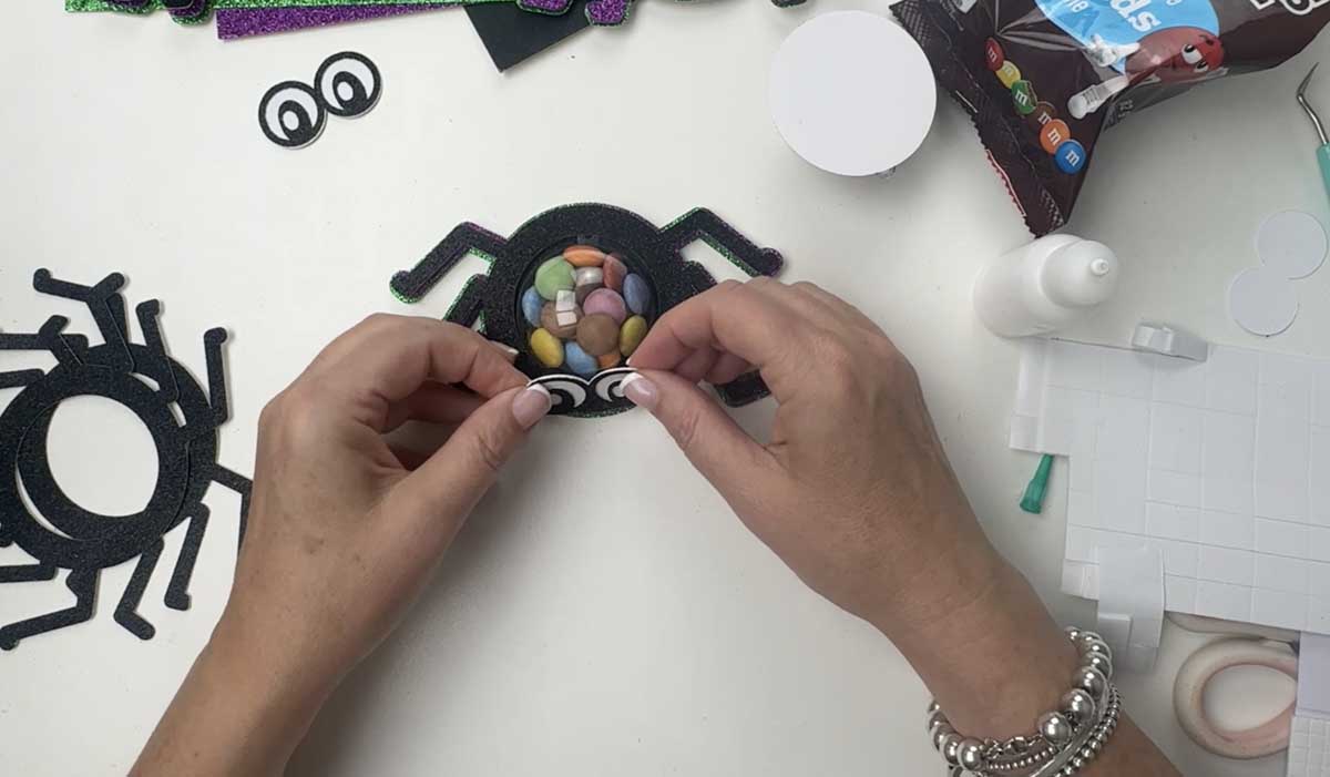 Stick the eyes onto your candy spider Halloween treat